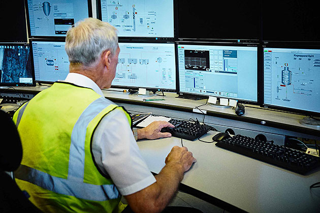 Worker monitoring production at sugar factory